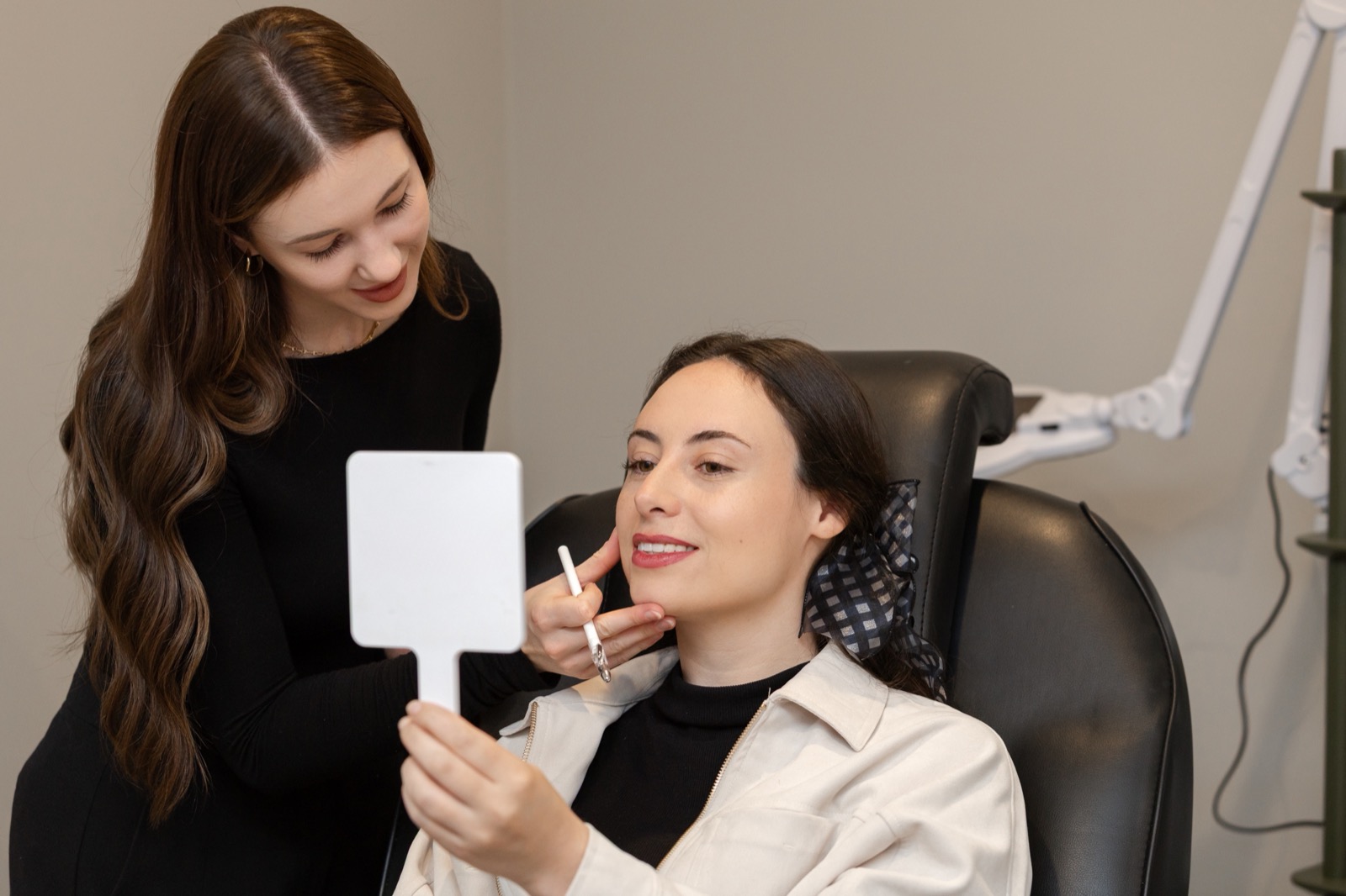 Jab Lab Melbourne nurse showing a client their reflection during a pigmentation consultation